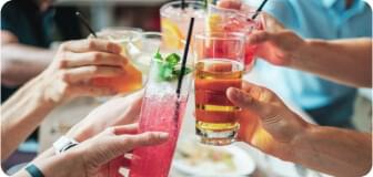 people raising their glasses to cheers